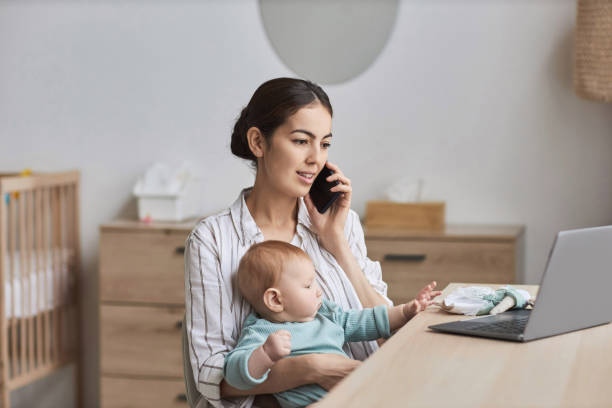 istock Young Woman with Baby Working From Home 1819849993