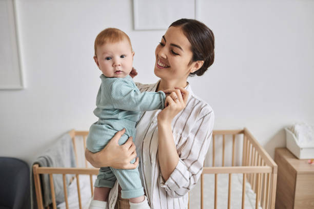 istock Happy Young Mother Holding Baby 1819850031