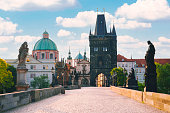 Charles bridge with old town bridge tower during sunrise in Prague Czech Republic