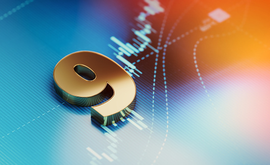 Gold colored number 9 over blue financial chart. Horizontal composition with selective focus and copy space. Finance and stock market concept.