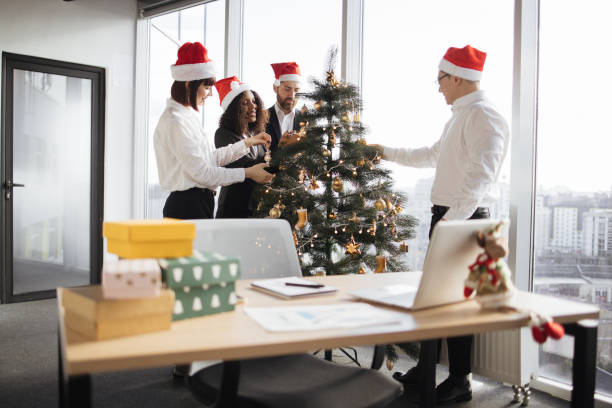 istock Multiethnic group of coworkers decorating christmas tree. 1819858473