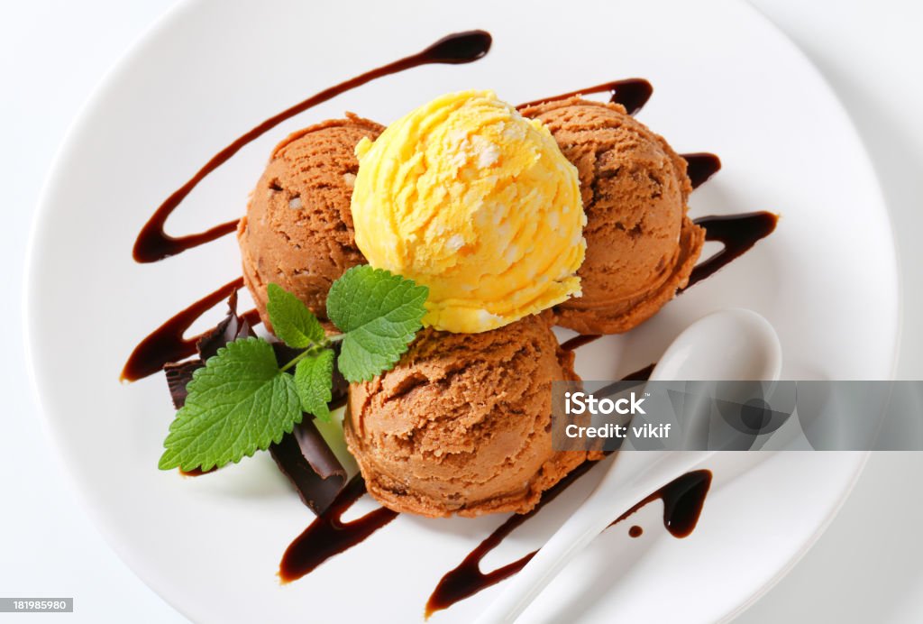 Ice cream with chocolate syrup Scoops of ice cream garnished with chocolate syrup Chocolate Stock Photo