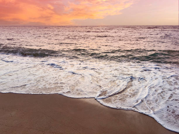 istock Sunset scene with wave water in the Tropical summer beach with  sandy beach background 1819864354