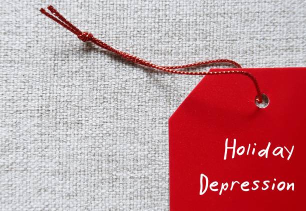 istock Red tag on copy space background written Holiday Depression-  means sadness in festive time, feelings of loneliness or relationship trouble, loss or estranged from loved ones or struggling with mental health issue 1819865907