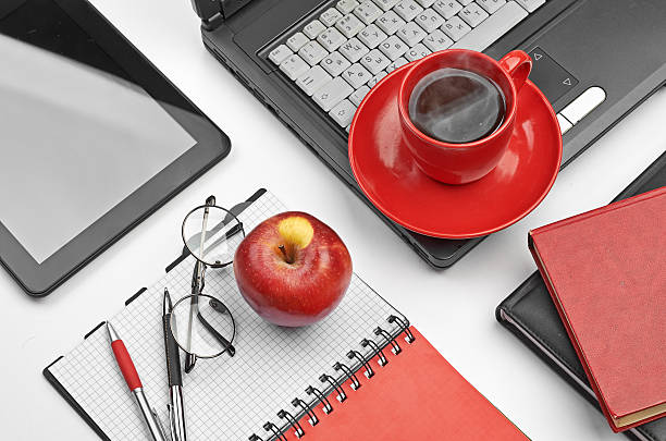 istock Laptop and office supplies on white 181987038