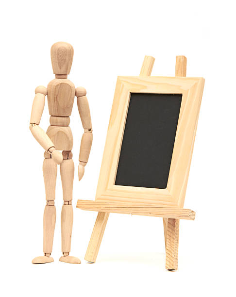 istock Wooden concept of mannequin in pose with wood frame 181987231