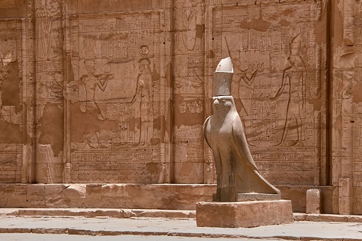 A stone statue of the bird representing Horus at the entrance to the temple of Edfu in Egypt.