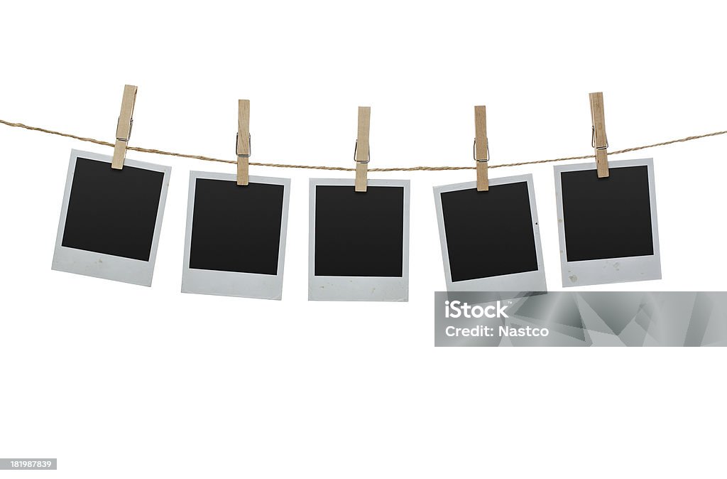Blank photos on the clothesline Five blank photos hanging on the clothesline isolated on white background with clipping path for the inside of the frames Instant Print Transfer Stock Photo
