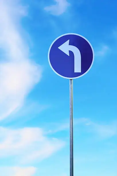left turn traffic sign over blue sky