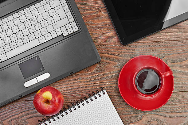 istock Laptop and office supplies on wooden table 181989603
