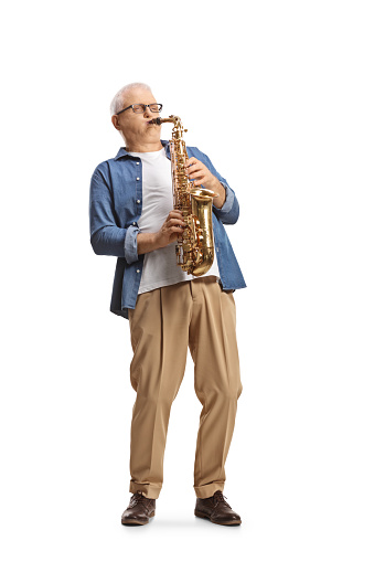 Full length shot of a casual mature man playing a saxophone isolated on white background