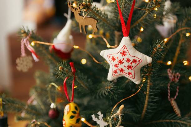istock Set of ornaments hanging off a traditional Christmas tree. 1819909729