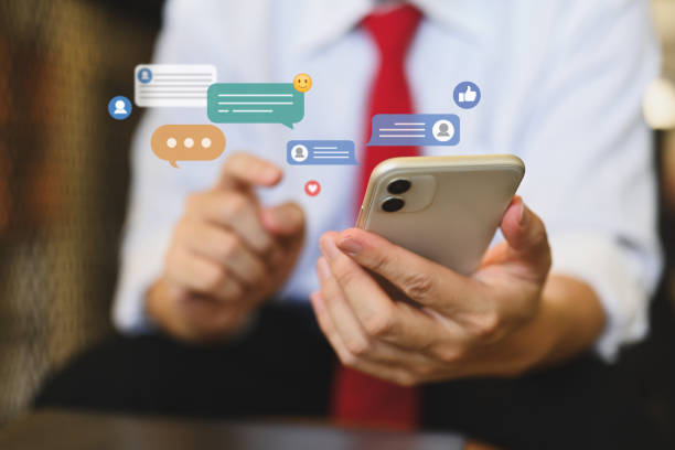 istock Businessman using mobile phone with icons social media notifications, messages and comments 1819914502