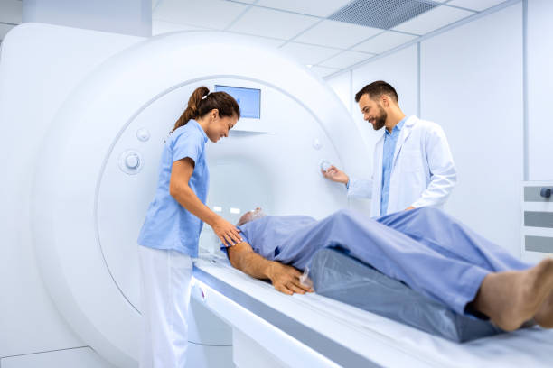 istock Doctors preparing patient for full body MRI scanning procedure inside hospital. 1819915545