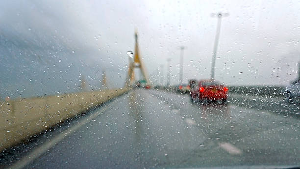istock Driving in rain with street view 181992150