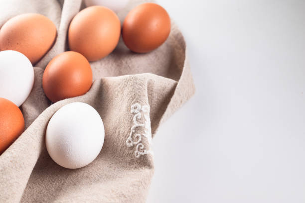 istock Chicken eggs on linen napkin on white background. 1819940448