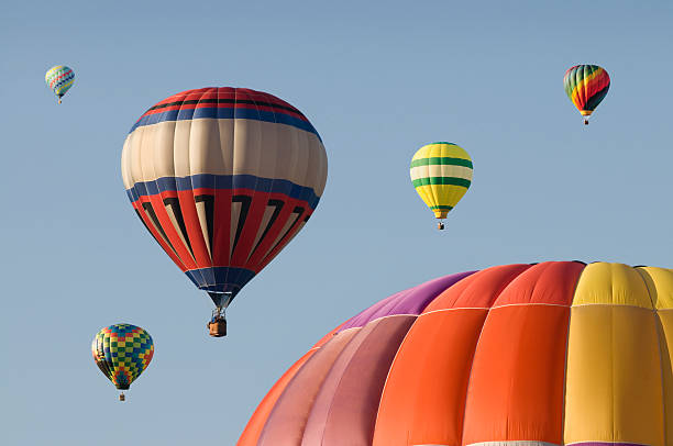 istock Hot-air Balloons Floating in a Blue Sky 181995405