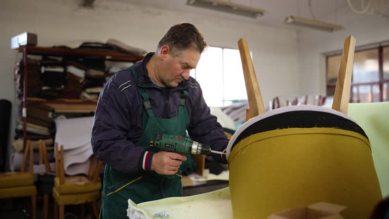 Mature man upholstering armchair