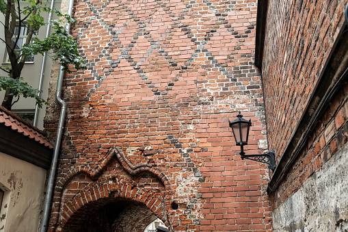 Ancient old brick wall with arch entrance in a famous landmark in Riga, Latvia