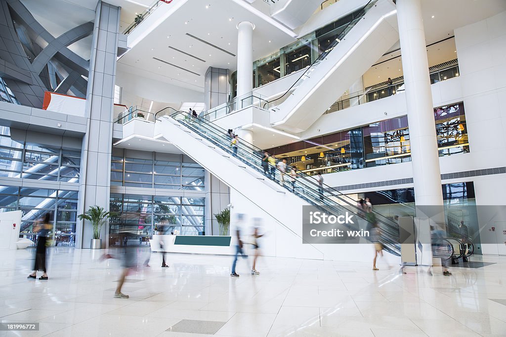 busy shopping mall busy shopping mall, long exposure time, shoppers moving are deliberately blurred Shopping Mall Stock Photo