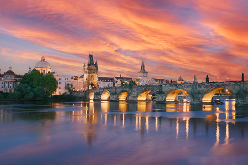Classic Prague panorama with Old Town Bridge Tower and Charles bridge over Vltava river at sunset, Czech Republic