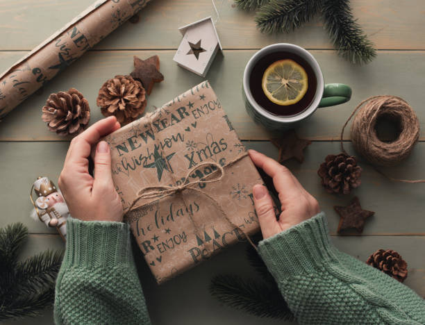 istock Women's hands hold a New Year's gift, top view. 1819985178