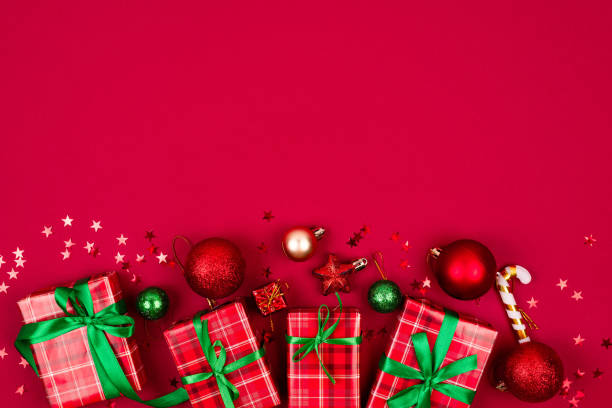 istock Christmas composition. Red gift boxes with green ribbon at red background. christmas baubles. Merry Christmas greeting card, 1819998644