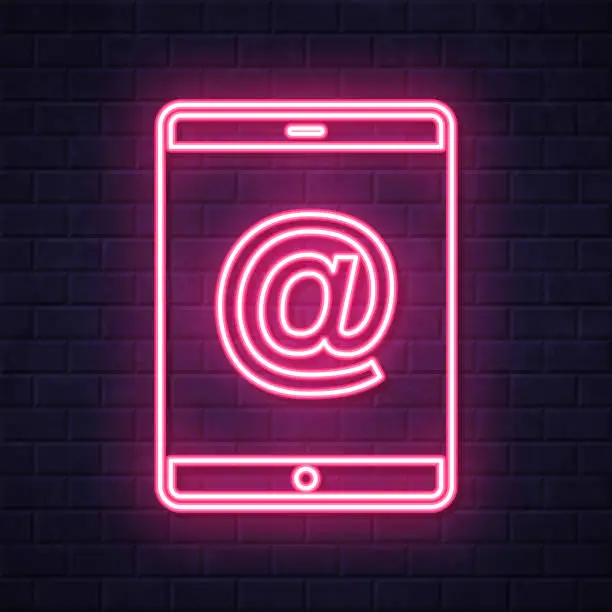 Vector illustration of Tablet PC with At symbol. Glowing neon icon on brick wall background