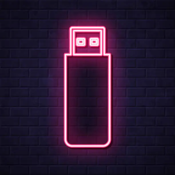 Vector illustration of USB flash drive. Glowing neon icon on brick wall background