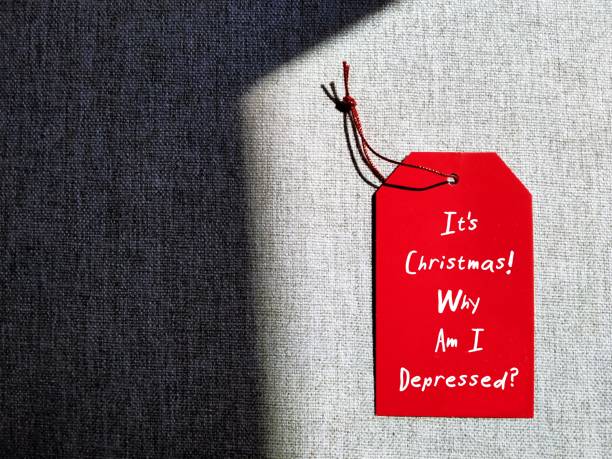 istock Red tag on copy space background with handwritten text  It's Christmas! Why Am I Depressed? concept of Christmas Holisay Blues, Holiday depression, feel down or sad in festive time 1820004031