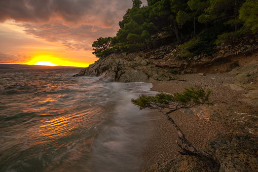 Spectacular landscape of the rocky coastline on the Makarska Riviera during a stormy sunset