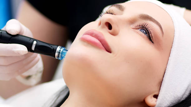 istock Professional dermatologist in medical gloves doing hydro peeling procedure for beautiful woman patient in cosmetology clinic. Close up facial treatment. 1820028531