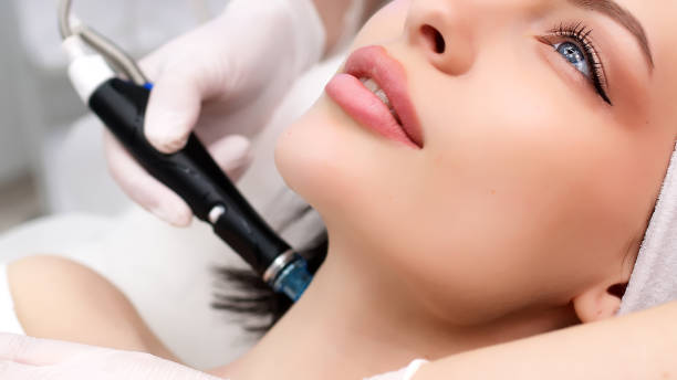 istock Professional dermatologist in medical gloves doing hydro peeling procedure for beautiful woman patient in cosmetology clinic. Close up facial treatment. 1820029059