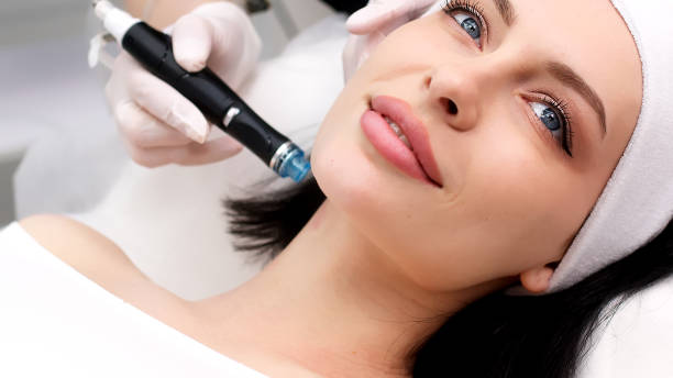 istock Professional dermatologist in medical gloves doing hydro peeling procedure for beautiful woman patient in cosmetology clinic. Close up facial treatment. 1820029067