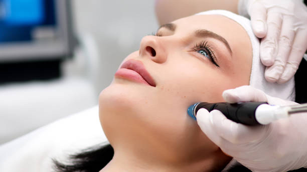 istock Professional dermatologist in medical gloves doing hydro peeling procedure for beautiful woman patient in cosmetology clinic. Close up facial treatment. 1820029608