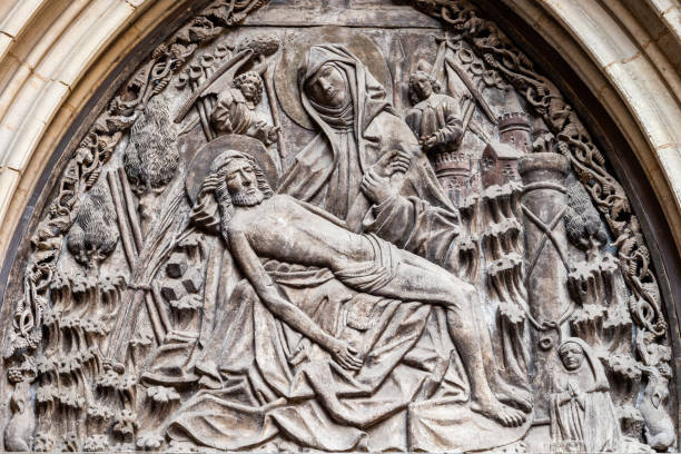 Gothic Pieta sculpture in Barcelona Tympanum relief carved by Michael Lochner in 15th century above rear entrance to Barcelona Cathedral pieta stock pictures, royalty-free photos & images
