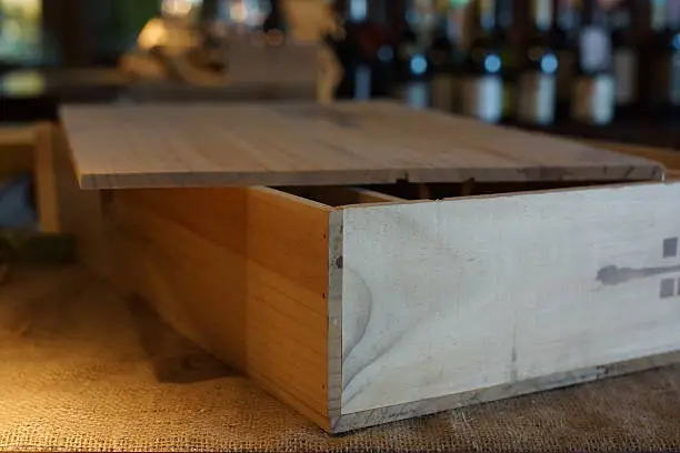 Wooden box for wine bottles on the table.