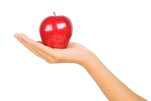 istock female hand with a red apple on white 182006334