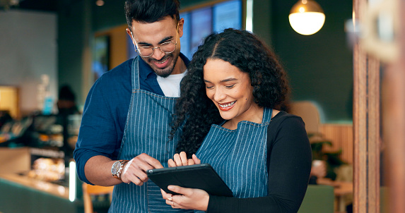 Cafe, business owner and teamwork on tablet for barista training, review sales and online management in hospitality. Happy woman, manager or waiter typing on digital technology for menu or planning