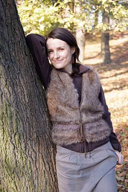 Autumn woman leaning tree stock photo