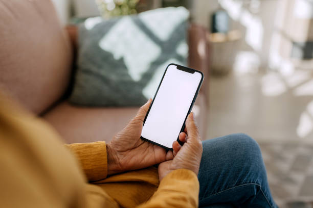 istock Senior woman using smart phone with blank white screen 1820074244