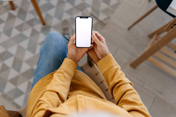 istock Senior woman using smart phone with blank white screen 1820074245