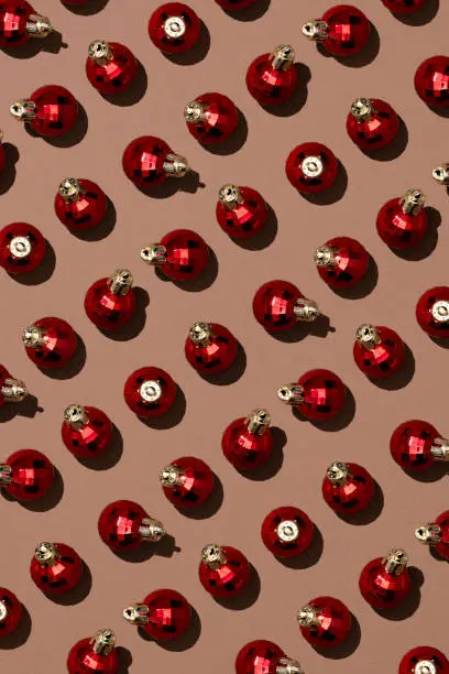 Photo of Shiny red Christmas balls on brown background