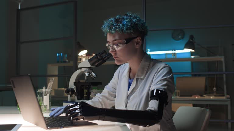 Female Scientist with Prosthetic Arm Working in Chemistry Lab