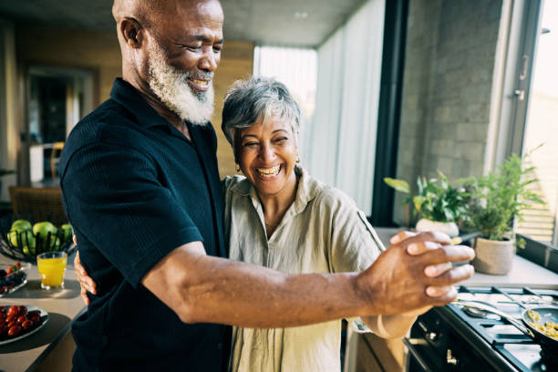istock Active Retired African-American Couple Sharing a Laugh in Modern Home Kitchen 1820110473
