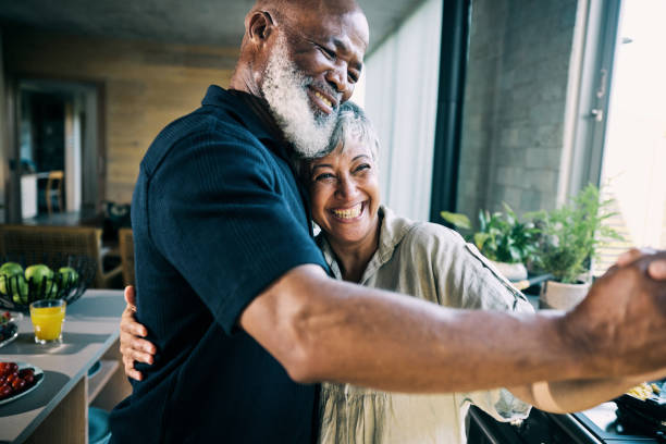 istock Active Retired African-American Couple Sharing a Laugh in Modern Home Kitchen 1820110485