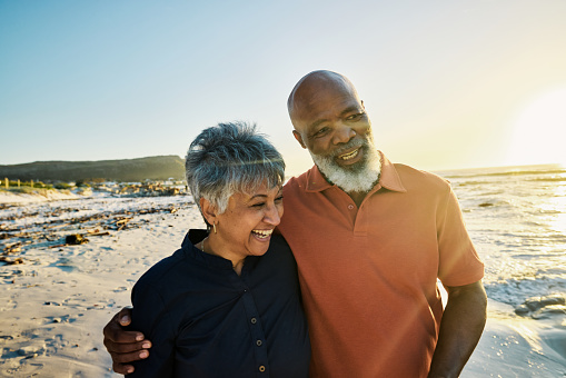 Generation X African-American Couple in Retirement Walking Hand in Hand Along Shoreline