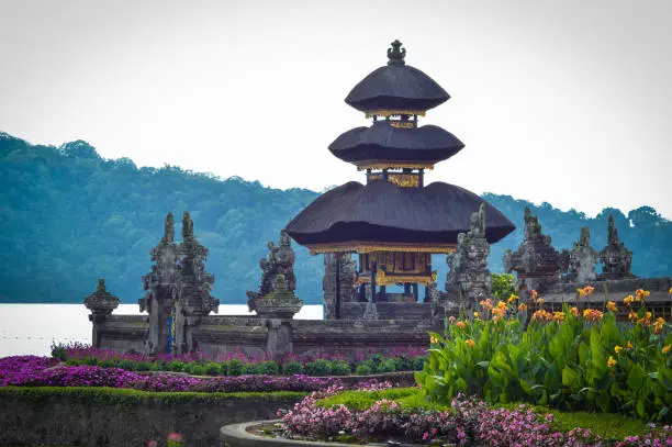 Beautiful Ancient Balinese Hindu Temple With Tiered Meru Structures On The Edge Of A Mountain Lake At Bedugul, Bali