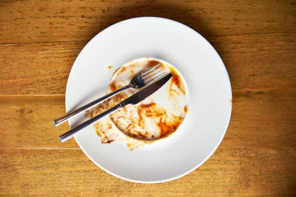 istock Forks arranged on a white ceramic plate with sauce residue 1820154663