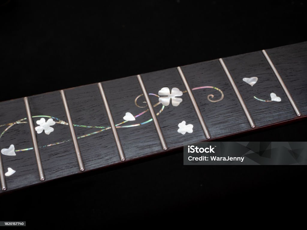 close up shot finger board  pearl inlay , heart and flower , acoustic guitar Acoustic Guitar Stock Photo